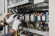 © Nonthanat - Electrician engineer tests electrical installations and wires on relay protection system.