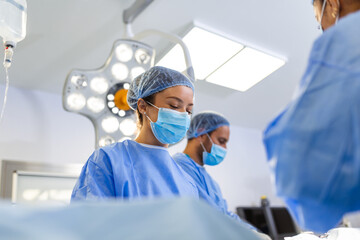 Wall Mural - Doctor and assistant nurse operating for help patient from dangerous emergency case .Surgical instruments on the sterile table in the emergency operation room in the hospital.Health care and Medical