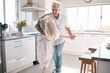 © Lumeez/peopleimages.com - Senior couple dancing, kitchen and happiness with love, care and support in morning at house. Elderly man, old woman and dance together with smile, hands and support in retirement in home with trust