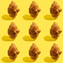 Wall Mural - Seamless pattern with chocolate croissant on yellow background.	