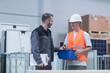 © Cavan Images - Store workers working in a distribution warehouse, Freiburg im Breisgau, Baden-Württemberg, Germany