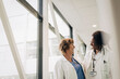 © Maskot - Happy multiracial female physicians looking at each other in hospital