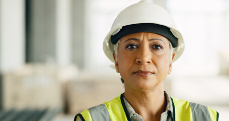 Wall Mural - Woman, serious face and construction worker, engineer at work site and business, building trade industry portrait. Mature person, safety helmet and professional, engineering and construction job.