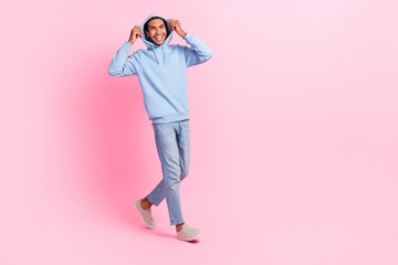 Wall Mural - Photo of cheerful nice man wear blue street style clothes moving empty space new boutique isolated on pink color background