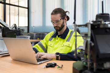 male engineer using laptop computer for training programmable logic controller. male programmer crea