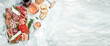 © Надія Коваль - Salami, sliced ham, sausage, prosciutto, bacon, toasts, olives. Meat antipasto platter. Long banner format. top view