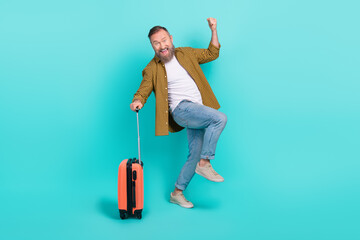 Wall Mural - Photo of overjoyed stylish man celebrate vacation abroad resort hotel comfort trip low price tickets isolated on cyan color background