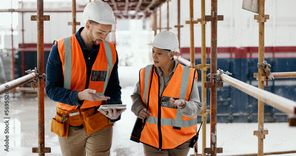 Construction worker, working together and conversation with tablet ...