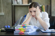 © Songsak C - Businesswomen working in an office, young businesswomen stressed from work overload with a lot of files on the desk.
