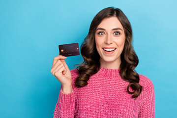 Sticker - Photo of astonished lovely lady wear trendy clothes demonstrate offer bank card empty space isolated on blue color background