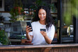 © Nina L/peopleimages.com - Woman, phone and credit card with smile for ecommerce, online shopping or purchase at coffee shop. Happy female customer on smartphone for internet banking, app or wireless transaction at cafe