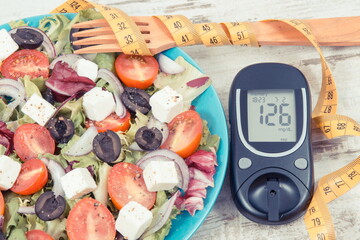 Wall Mural - Glucometer for checking sugar level, tape measure and fresh greek salad. Diabetes and healthy lifestyles