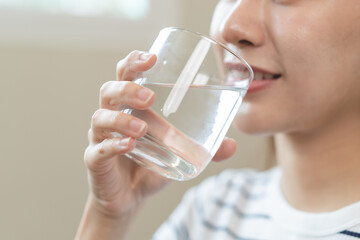 Clean freshwater concept. Woman drink mineral water in the morning for good health.