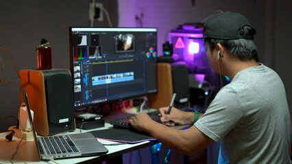 Wall Mural - Content creator working with computer for editing video footage