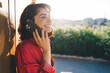 © BullRun - Positive woman talking on cellphone