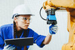 © gumpapa - female automation machine engineer student study and inspection control robot arm machine in university or factory workshop. AI robot technology new innovation trend for manufacturing in industry 5.0