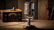Vintage Radio Microphone. A vintage radio microphone sits on a wooden desk alongside a vintage radiophone.