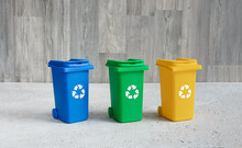 Multi-colored dustbins for organic, plastic and paper trash, waste recycling and conservation of the environment concept