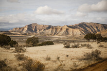 Wide View Of Bentonite Bookcliffs In Grand Junction Colorado Set Behind Dry Grassy Hills