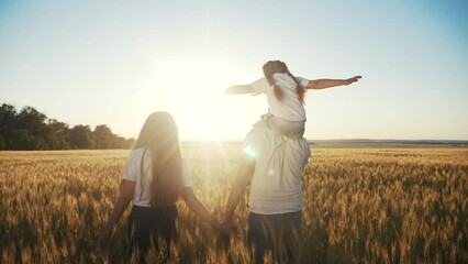 Wall Mural - people in the park. happy family silhouette walk. mom dad and daughters walk holding hands in the park. happy family kid a dream concept. parents and fun children sunset walking back silhouette