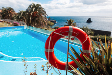 Lifebuoy near the pool and the ocean on the island of Madeira. Rescue and help, concept