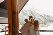 © Myroslava - Family standing on balcony covered in blanket in early morning enjoying good winter day in Alps.