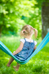 happy baby in a hammock outdoors in the park