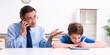 © Elnur - Busy father helping his son to prepare for exam