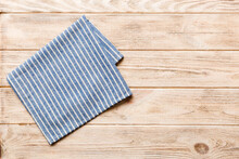 Top View With Blue Kitchen Napkin Isolated On Table Background. Folded Cloth For Mockup With Copy Space, Flat Lay. Minimal Style