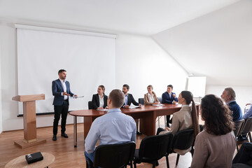 Poster - Business conference. People in meeting room listening to speaker report