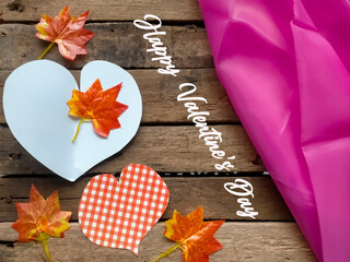 Wall Mural - autumn leaves on wooden background for valentine's day card