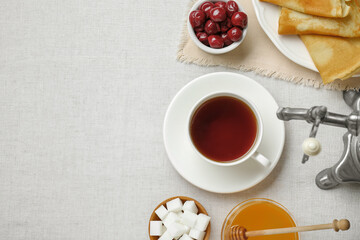 Wall Mural - Cup of aromatic tea and treats on table, flat lay. Space for text