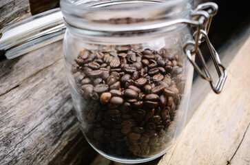 Wall Mural - roasted coffee bean in a glass jar