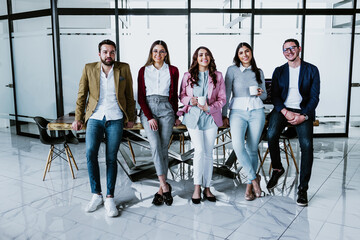 Wall Mural - group of young hispanic business people or teamwork working in casual clothes at office in Mexico Latin America