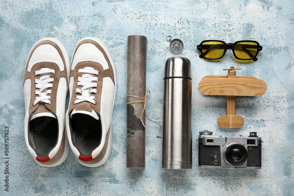 Compass with traveler accessories on grunge background