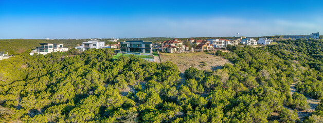 Wall Mural - Austin, Texas- Mountain top with mansions near the forest with trees. Rich neighborhood surrounded by green trees in a panoramic view.