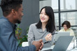 © AnnaStills - Asian young businesswoman discussing project on laptop together with her colleague while they sitting at table