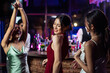 © Kawee - Asian beautiful woman having fun, dancing with music in bar restaurant.