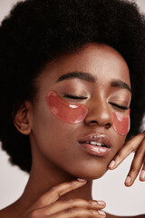 Sticker - Black woman with skincare, eye or face mask in studio with dermatology cosmetic product. Aesthetic model with hand on skin for spa collagen beauty patch for health, wellness and natural facial glow