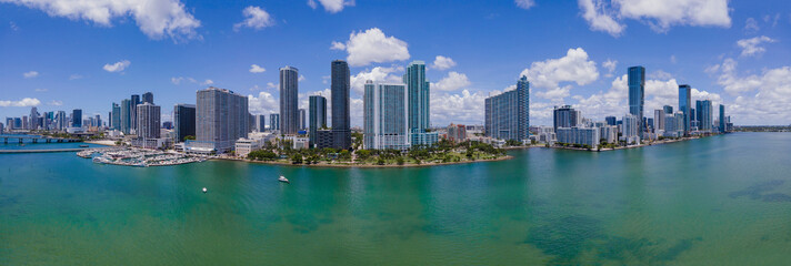 Wall Mural - Intracoastal Waterway and Miami Beach Florida against blue sky and clouds. Beautiful scenery of inland water channel with modern buildings in Miami skyline.