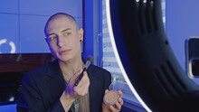 Bald Influencer Young Man Streaming Makeup Tutorial Video, Medium Closeup LGBT Concept. High Quality Photo