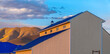 Eagle Mountain, Utah- Barn building against the mountain during sunset. Barn with beige steel wall claddings and blue roofs against the mountain and sky.