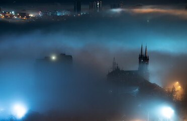 Fototapete - Cityscape night view. Fog over the city.
