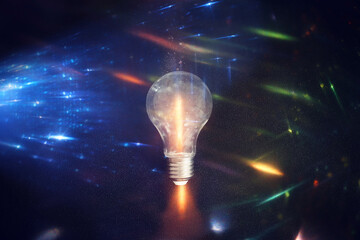 Poster - Light bulb over dark black background. Concept of creativity and innovation