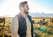 © K Davis/peopleimages.com - Sustainability, farming and man with cows on field, happy farmer in countryside with mountains, dairy and beef production. Nature, meat and milk farm, sustainable business in eco agriculture and food