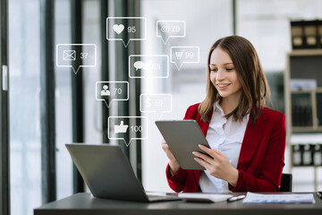 Wall Mural - woman typing tablet with laptop computer of social media and marketing virtual icons screen concept.