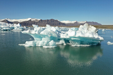 Wall Mural - blue iceberg floating over glacier lake