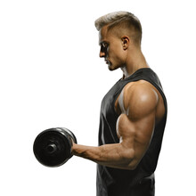 Handsome Power Athletic Man In Training Pumping Up Muscles With Dumbbell. Strong Bodybuilder With Perfect Deltoid Muscles, Shoulders, Biceps, Triceps And Chest. Close-up Of A Power Fitness Man.