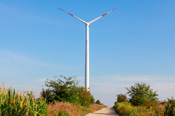 Wind turbine at countryside . One wind generator against sky 