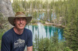 © Dirk - Caucasian tourist wearing a hat during summer posing in the mountains with view on upper Grassi lakes, Canmore, Alberta, Canada